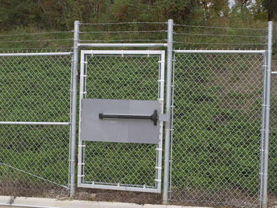 A small chain link fabric gate is fixed together with the chain link fence.